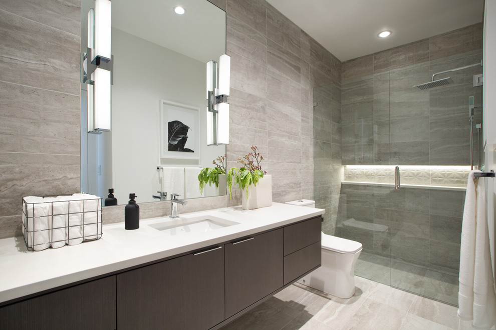 Inspiration for a small contemporary shower room bathroom in Vancouver with flat-panel cabinets, a built-in shower, a one-piece toilet, porcelain tiles, ceramic flooring, a submerged sink, engineered stone worktops, grey floors, a hinged door, white worktops, grey cabinets, grey tiles and a wall niche.