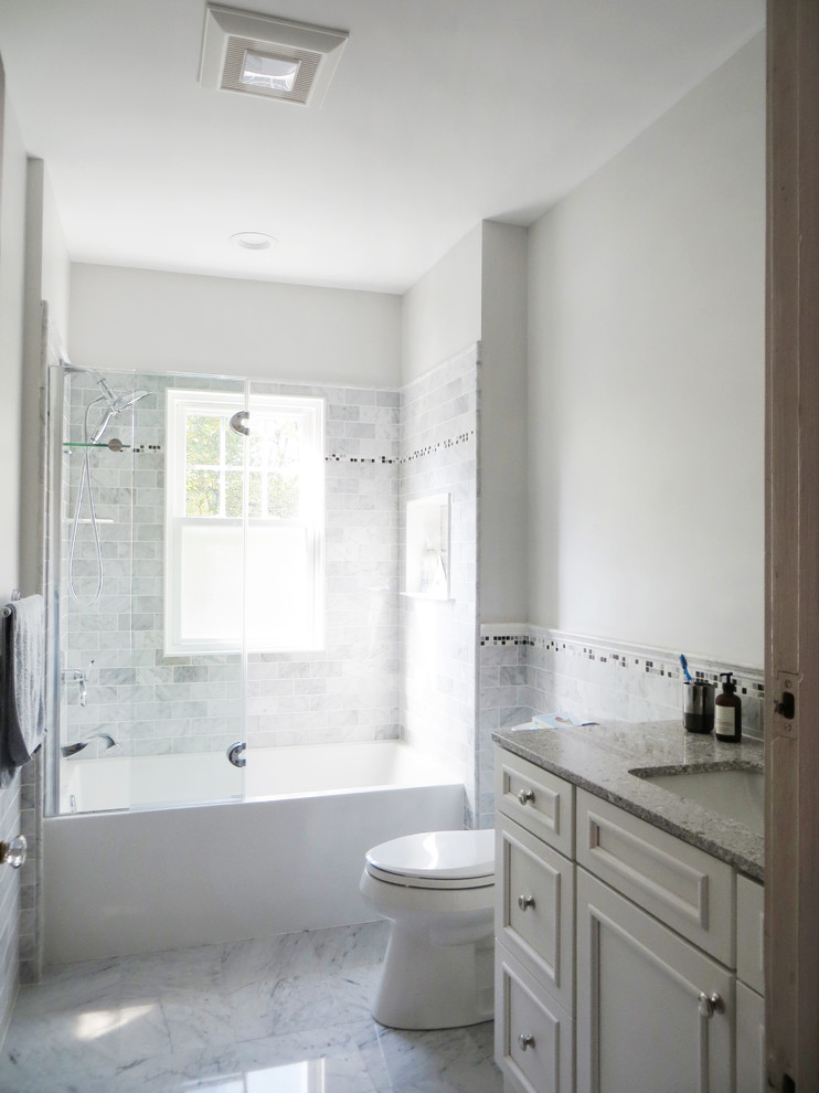 Idéer för små vintage grått badrum med dusch, med möbel-liknande, vita skåp, ett badkar i en alkov, en dusch/badkar-kombination, en toalettstol med hel cisternkåpa, grå kakel, stenkakel, vita väggar, klinkergolv i porslin, ett undermonterad handfat, bänkskiva i kvarts, grått golv och dusch med gångjärnsdörr