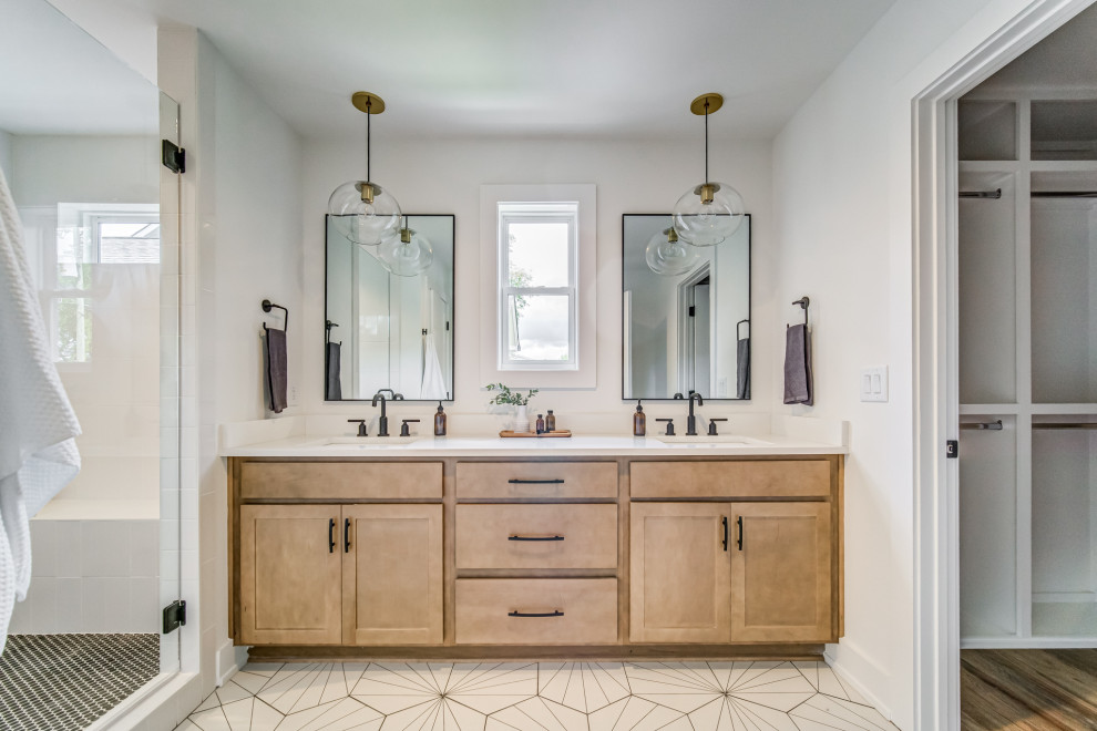 Photo of a traditional ensuite bathroom in Nashville with shaker cabinets, medium wood cabinets, an alcove shower, white walls, a submerged sink, white floors, a hinged door, white worktops, double sinks and a built in vanity unit.