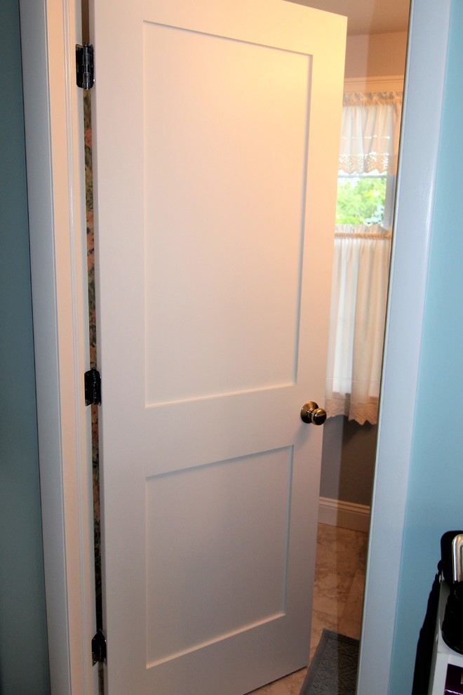 Photo of a medium sized traditional ensuite bathroom in Baltimore with recessed-panel cabinets, medium wood cabinets, an alcove bath, a shower/bath combination, a two-piece toilet, white tiles, ceramic tiles, blue walls, ceramic flooring, a submerged sink, multi-coloured floors and a shower curtain.