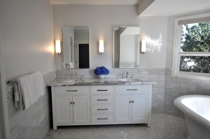 Large elegant master gray tile and marble tile terrazzo floor and gray floor freestanding bathtub photo in Other with shaker cabinets, white cabinets, gray walls, an undermount sink, granite countertops and gray countertops