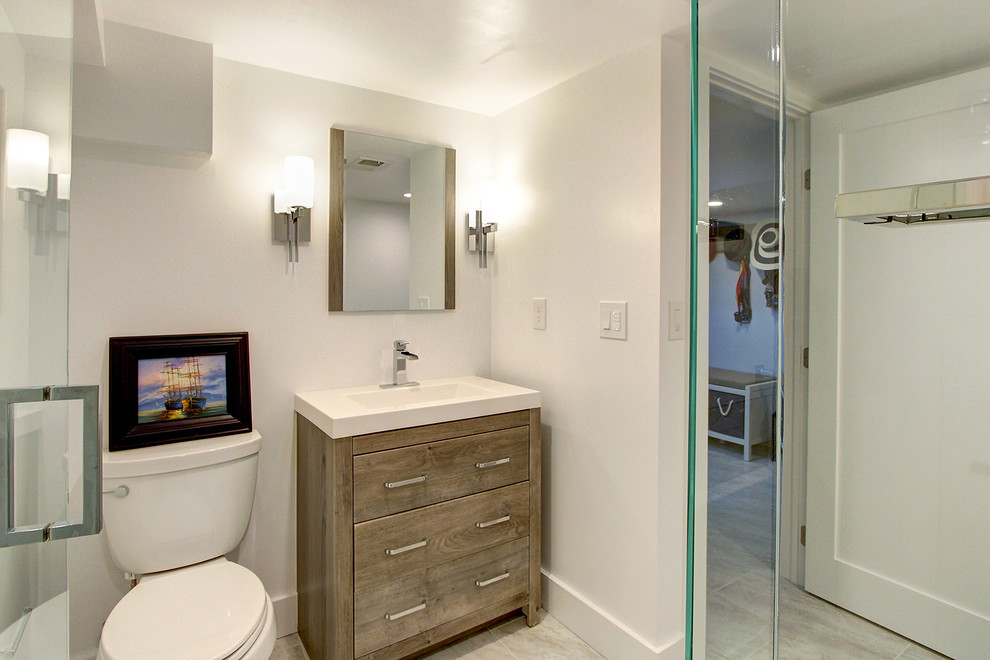 Medium sized classic shower room bathroom in Denver with flat-panel cabinets, dark wood cabinets, a built-in bath, an alcove shower, a one-piece toilet, beige tiles, ceramic tiles, white walls, ceramic flooring, an integrated sink, solid surface worktops, white floors, a hinged door and white worktops.