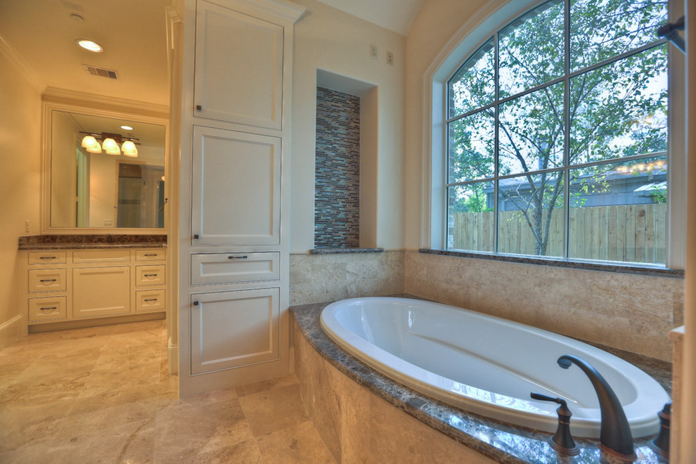 Example of a large classic master beige tile and stone tile travertine floor and beige floor bathroom design in Houston with recessed-panel cabinets, white cabinets, beige walls, an undermount sink and granite countertops