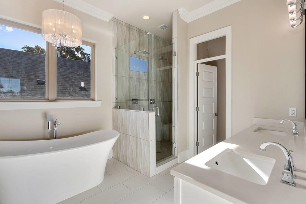 Bathroom - mid-sized transitional master white tile and ceramic tile ceramic tile and white floor bathroom idea in New Orleans with white cabinets, beige walls, recessed-panel cabinets, an undermount sink, quartz countertops and a hinged shower door