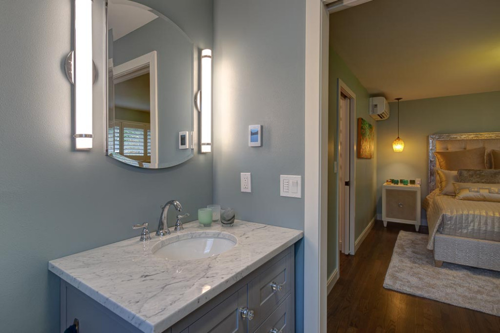 Mid-sized minimalist 3/4 white floor bathroom photo in Seattle with gray cabinets, a one-piece toilet and gray walls