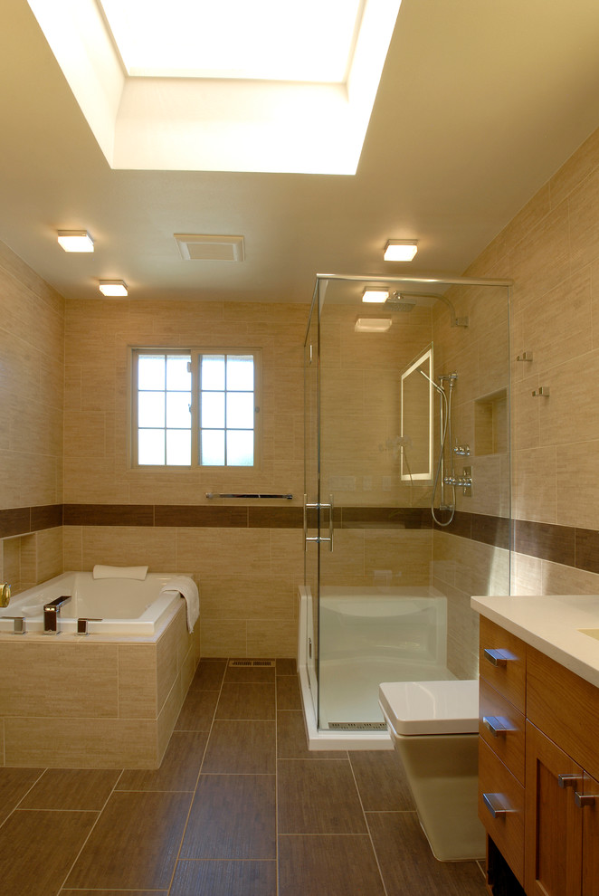 Small contemporary shower room bathroom in Seattle with a submerged sink, flat-panel cabinets, light wood cabinets, engineered stone worktops, a built-in bath, an alcove shower, a one-piece toilet, beige tiles, porcelain tiles, beige walls and porcelain flooring.