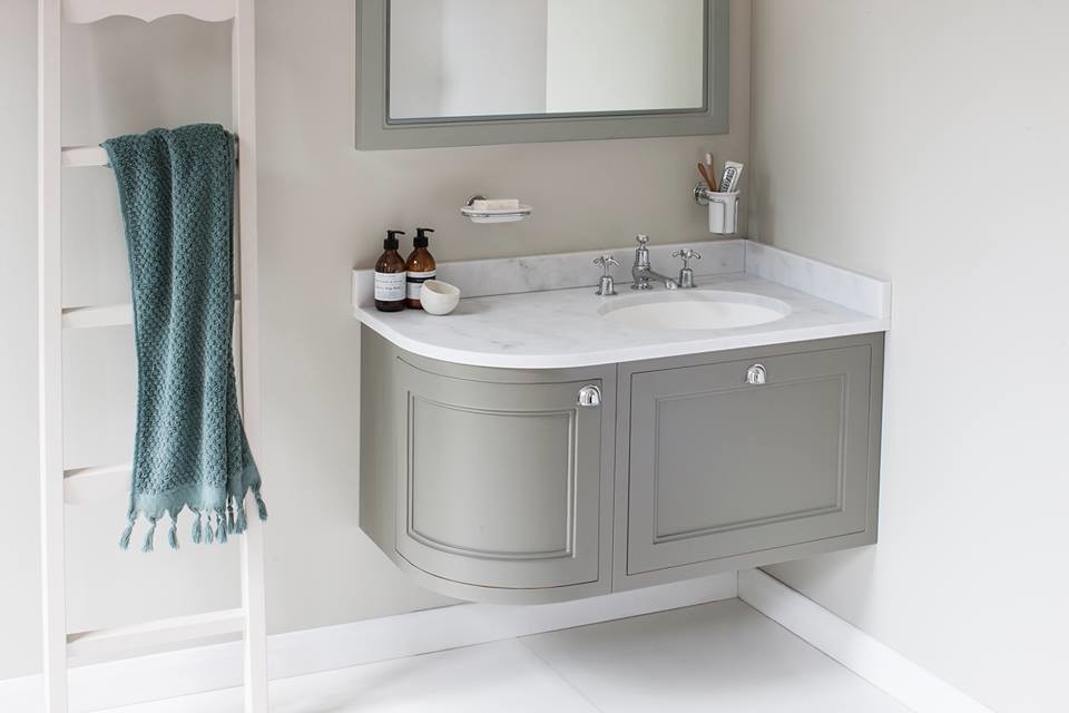 Photo of a medium sized classic family bathroom in Cambridgeshire with shaker cabinets, medium wood cabinets, a claw-foot bath, a built-in shower, a one-piece toilet, white tiles, ceramic tiles, white walls, porcelain flooring, a pedestal sink and marble worktops.