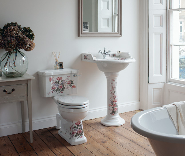 Inspiration for a medium sized traditional family bathroom in Cambridgeshire with shaker cabinets, medium wood cabinets, a claw-foot bath, a built-in shower, a one-piece toilet, white tiles, ceramic tiles, white walls, porcelain flooring, a pedestal sink and marble worktops.