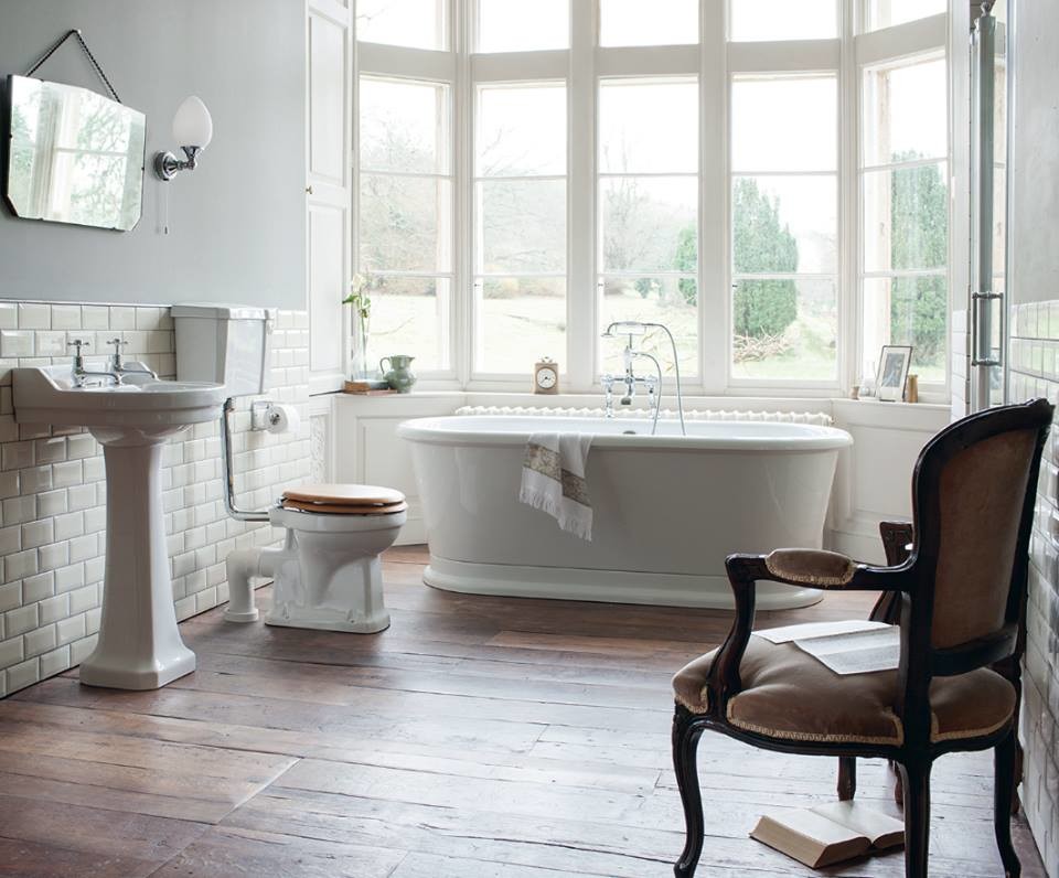 Design ideas for a medium sized traditional family bathroom in Cambridgeshire with shaker cabinets, medium wood cabinets, a claw-foot bath, a built-in shower, a one-piece toilet, white tiles, ceramic tiles, white walls, porcelain flooring, a pedestal sink and marble worktops.