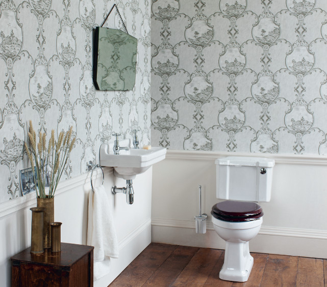 Photo of a medium sized traditional cloakroom in Cambridgeshire with shaker cabinets, medium wood cabinets, a one-piece toilet, white tiles, ceramic tiles, white walls, porcelain flooring, a pedestal sink and marble worktops.
