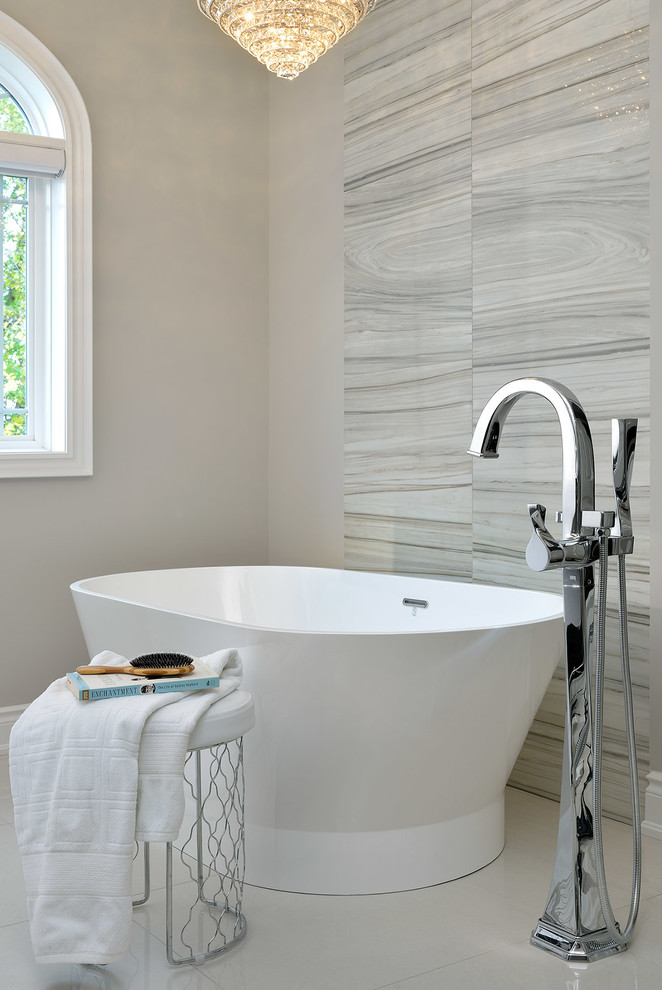 Inspiration for a large transitional master porcelain tile freestanding bathtub remodel in Toronto with gray walls