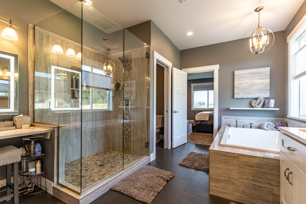 This is an example of a traditional ensuite bathroom in Seattle with shaker cabinets, white cabinets, a built-in bath, a corner shower, grey tiles, marble tiles, grey walls, slate flooring, a submerged sink, engineered stone worktops, grey floors, a hinged door and white worktops.
