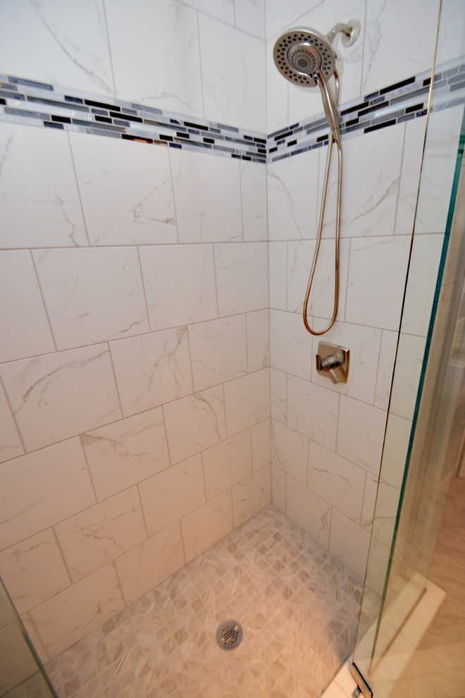 Example of a classic master gray tile and porcelain tile porcelain tile double shower design in Louisville with recessed-panel cabinets, dark wood cabinets, a two-piece toilet, blue walls, an undermount sink and granite countertops