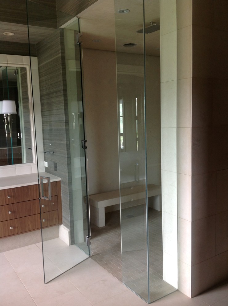 Photo of a medium sized contemporary bathroom in Denver with a submerged bath, a built-in shower, beige tiles, stone tiles and limestone flooring.