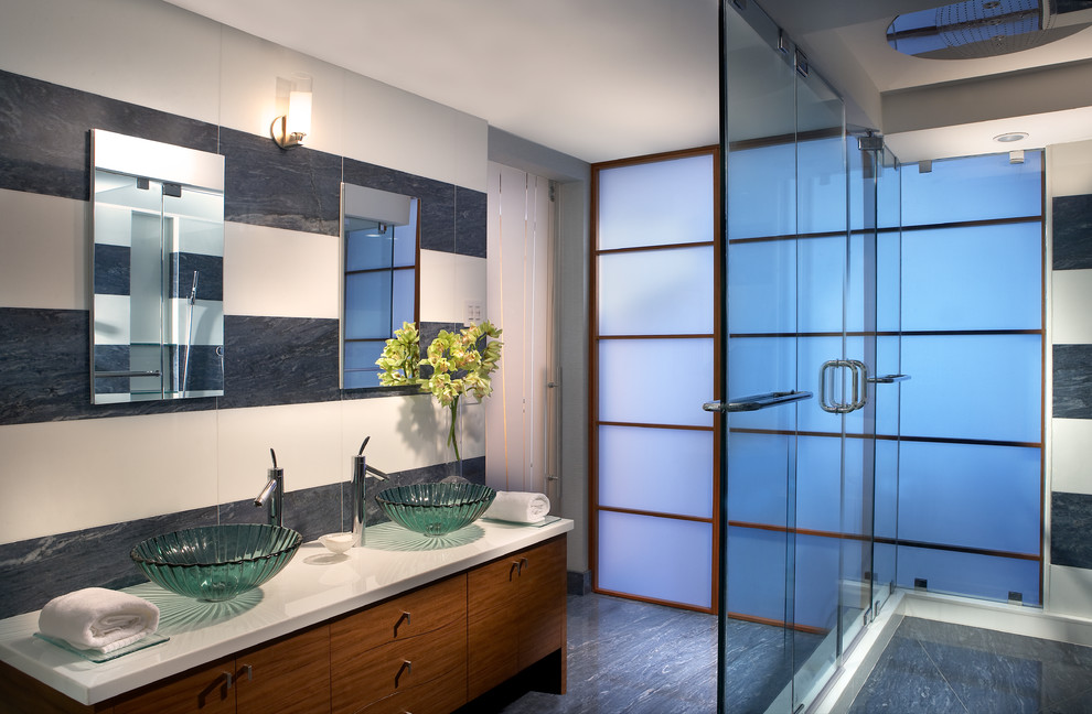 Expansive contemporary ensuite bathroom in Miami with a vessel sink, freestanding cabinets, white cabinets, marble worktops, a double shower, a one-piece toilet, white tiles, glass tiles, white walls and marble flooring.
