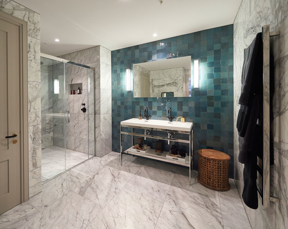 This is an example of a large contemporary shower room bathroom in London with a built-in shower and blue tiles.
