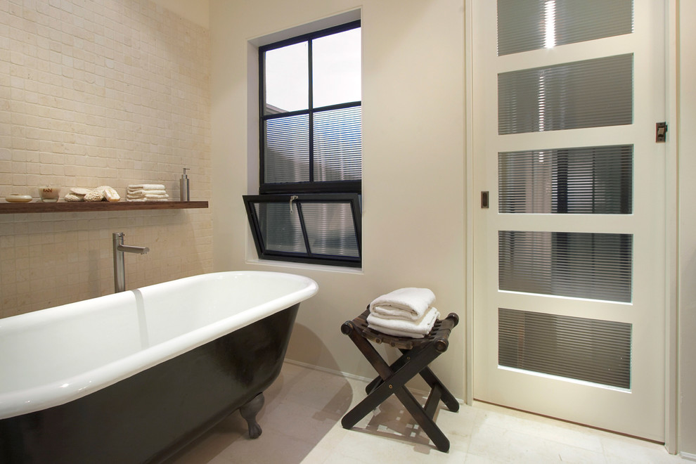 Example of a mid-sized classic master stone tile porcelain tile claw-foot bathtub design in Toronto with white walls