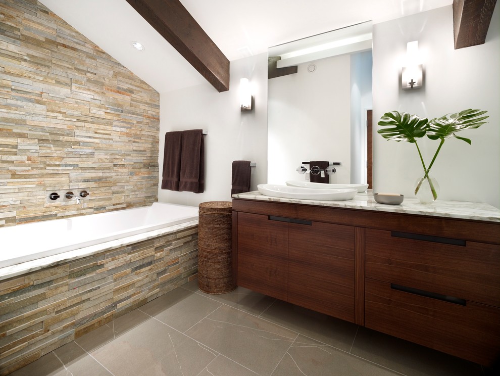 Drop-in bathtub - mid-sized contemporary master brown floor drop-in bathtub idea in Vancouver with flat-panel cabinets, dark wood cabinets, white walls, a vessel sink and marble countertops