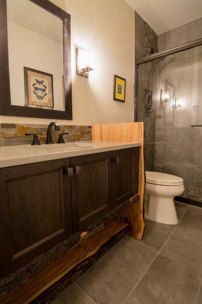 Alcove shower - mid-sized transitional alcove shower idea in Calgary with recessed-panel cabinets, a two-piece toilet, beige walls, an undermount sink, dark wood cabinets and beige countertops