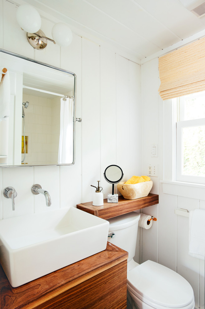Design ideas for a small beach style bathroom in Portland Maine with flat-panel cabinets, medium wood cabinets and white walls.