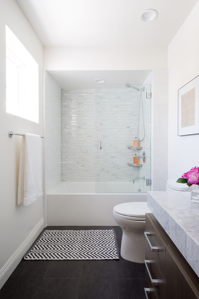 Mid-sized trendy 3/4 slate floor and brown floor bathroom photo in Los Angeles with flat-panel cabinets, brown cabinets, a two-piece toilet, white walls, a vessel sink, granite countertops and a hinged shower door