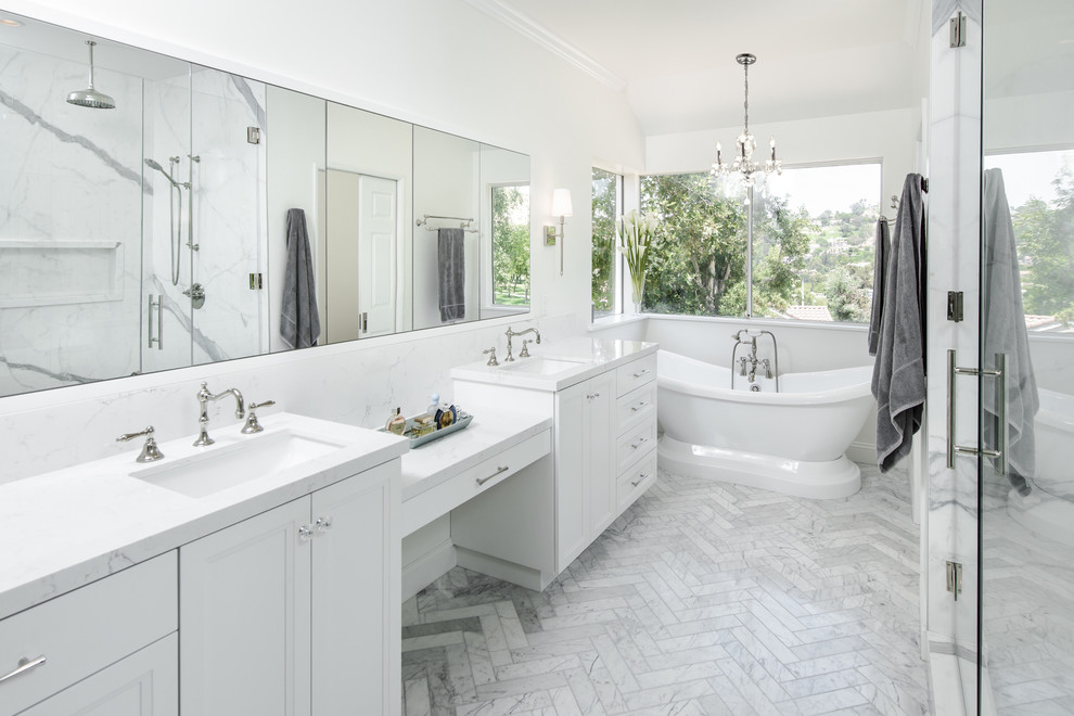 Large elegant master white tile and porcelain tile marble floor and white floor bathroom photo in Los Angeles with shaker cabinets, white cabinets, a one-piece toilet, white walls, a console sink, quartzite countertops and a hinged shower door