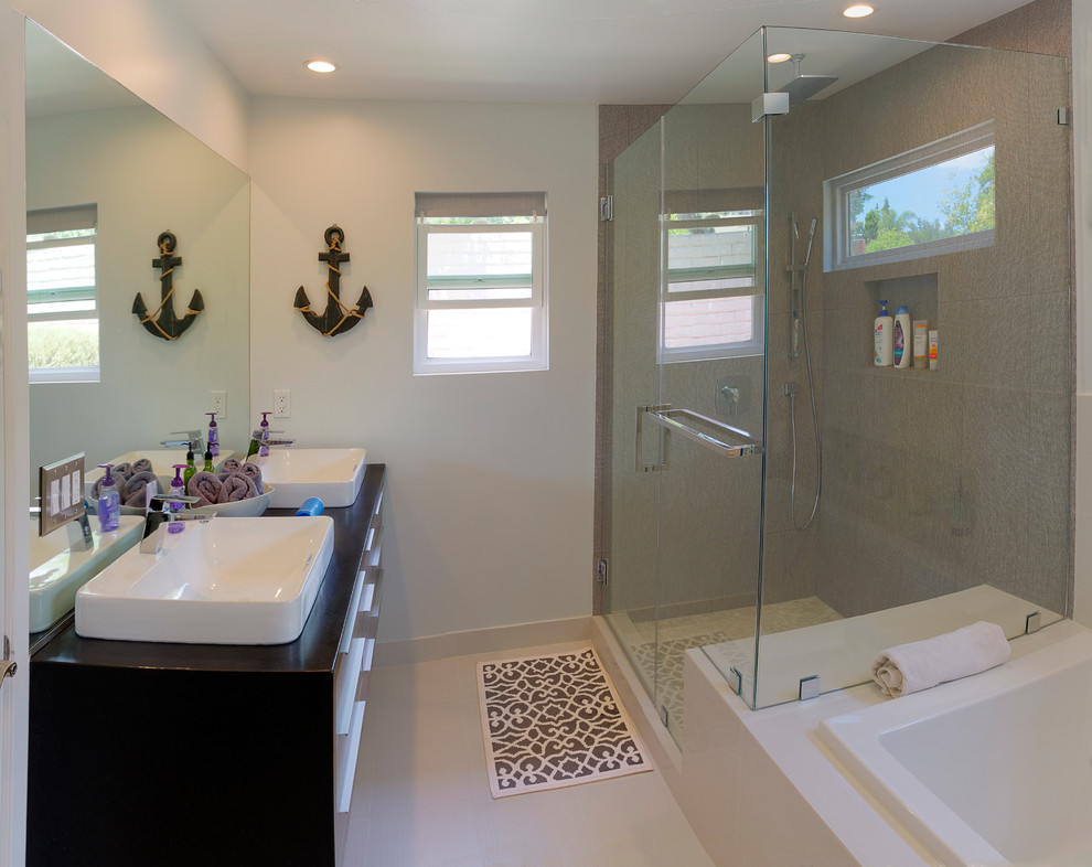 Minimalist beige tile and porcelain tile porcelain tile bathroom photo in Los Angeles with a vessel sink, wood countertops and multicolored walls