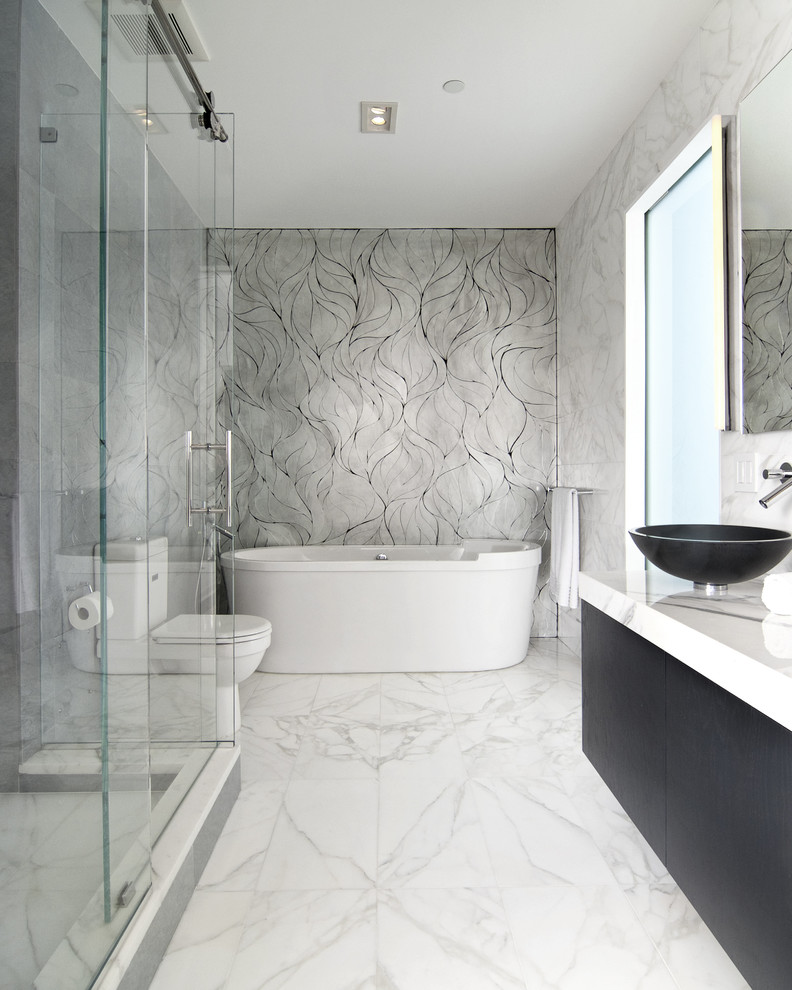 Design ideas for a modern ensuite bathroom in New York with a vessel sink, flat-panel cabinets, dark wood cabinets, a corner shower, mosaic tiles, marble flooring, grey walls and grey tiles.