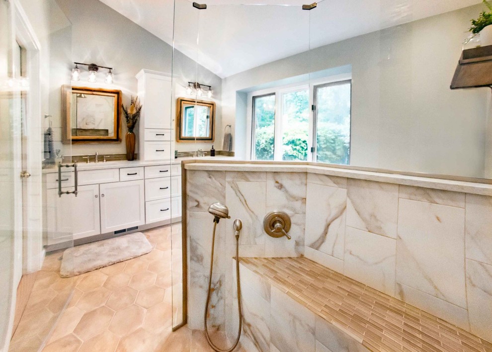 This is an example of a medium sized classic grey and cream ensuite bathroom in Detroit with white cabinets, a built-in shower, a two-piece toilet, white tiles, a submerged sink, engineered stone worktops, beige floors, a hinged door, porcelain tiles, porcelain flooring, white worktops, shaker cabinets, grey walls, double sinks and a built in vanity unit.