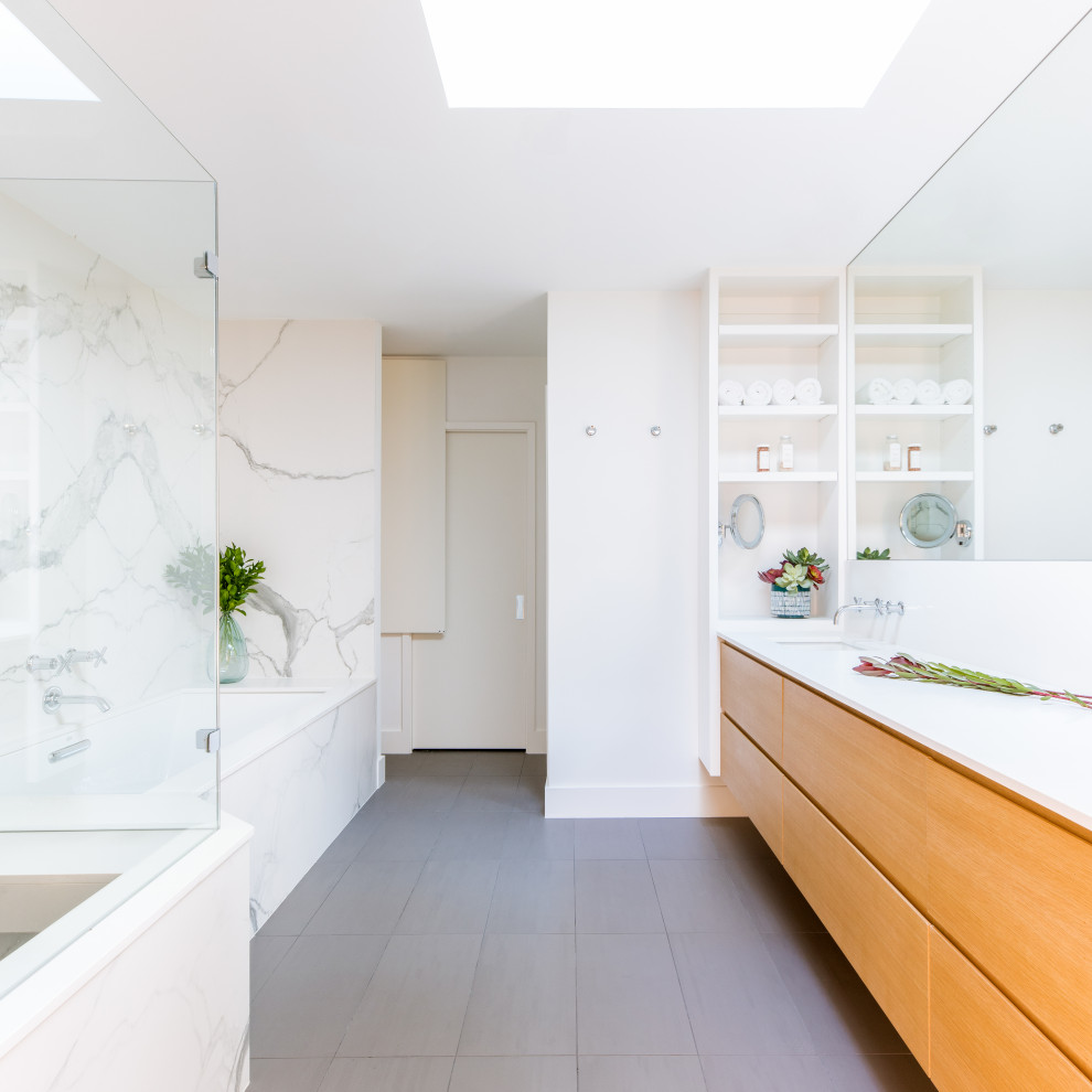 Retro bathroom in Dallas with flat-panel cabinets, medium wood cabinets, a submerged bath, a corner shower, white tiles, white walls, a submerged sink, grey floors, white worktops, a single sink and a floating vanity unit.