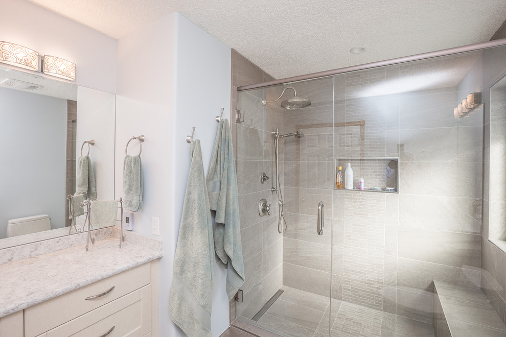 Mid-sized transitional master gray tile and porcelain tile porcelain tile alcove shower photo in Calgary with shaker cabinets, white cabinets, a one-piece toilet, an undermount sink, blue walls and granite countertops
