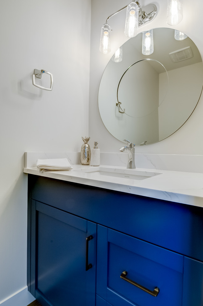 Photo of a small contemporary shower room bathroom in Calgary with shaker cabinets, blue cabinets, white tiles, stone slabs, grey walls, vinyl flooring, a submerged sink, engineered stone worktops and brown floors.