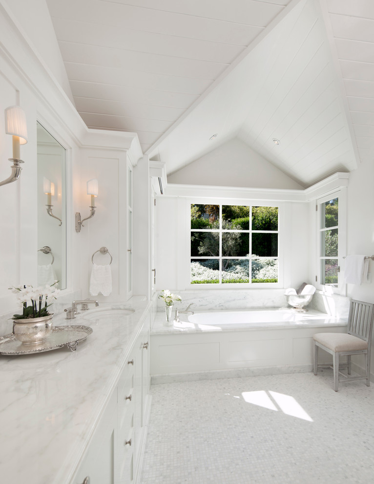 Bathroom - traditional white tile mosaic tile floor bathroom idea in Santa Barbara with an undermount sink, white cabinets, marble countertops, an undermount tub, white walls, shaker cabinets and white countertops