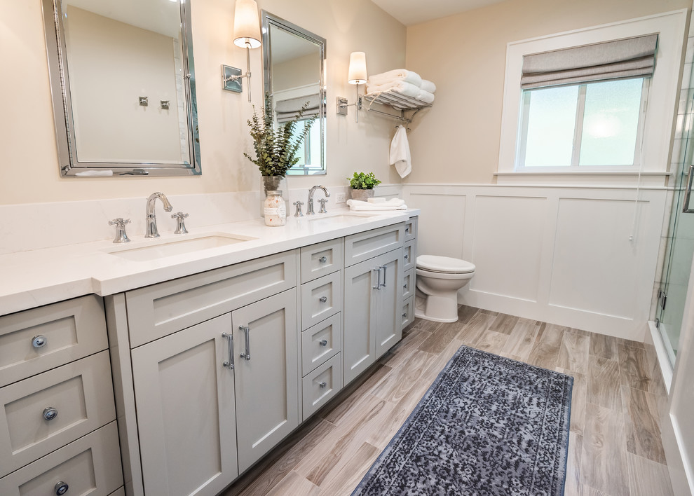 Bathroom - mid-sized traditional master white tile and subway tile porcelain tile and beige floor bathroom idea in San Diego with shaker cabinets, gray cabinets, gray walls, an undermount sink, quartz countertops, a hinged shower door and white countertops