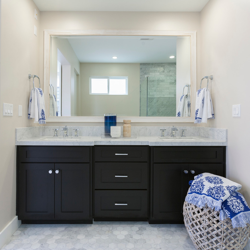 Inspiration for a coastal master gray tile and stone tile marble floor bathroom remodel in Orange County with an undermount sink, shaker cabinets, black cabinets, marble countertops, a two-piece toilet and gray walls