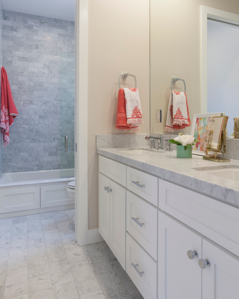 Bathroom - coastal kids' gray tile and stone tile marble floor bathroom idea in Orange County with an undermount sink, shaker cabinets, white cabinets, marble countertops, a two-piece toilet and gray walls