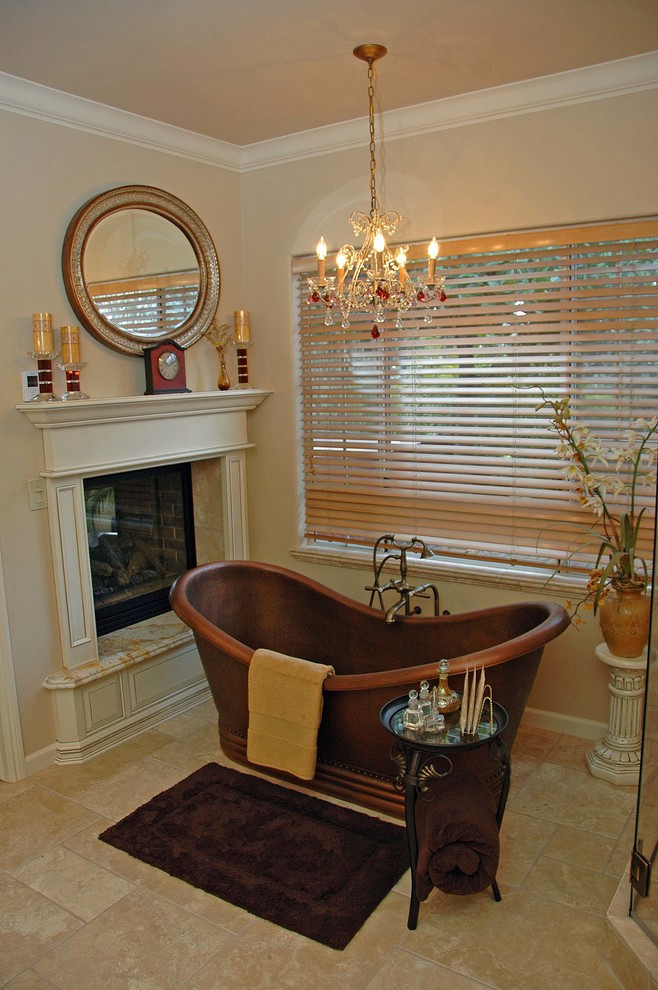 Large elegant master travertine floor and beige floor freestanding bathtub photo in San Francisco with beige walls
