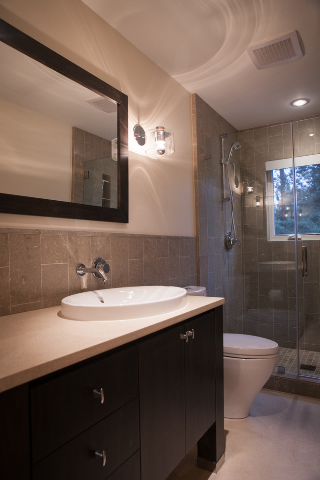 Example of a mid-sized minimalist master gray tile and stone tile limestone floor alcove shower design in San Francisco with a drop-in sink, raised-panel cabinets, dark wood cabinets, quartzite countertops, a one-piece toilet and beige walls