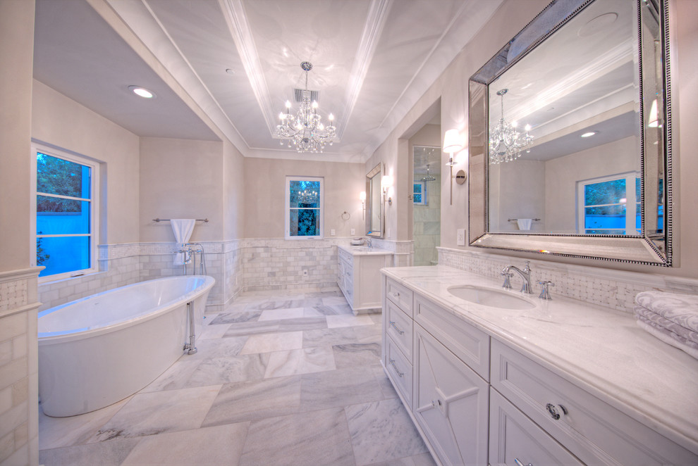 Bathroom - huge traditional master gray tile, white tile and stone tile marble floor bathroom idea in Phoenix with recessed-panel cabinets, white cabinets, a two-piece toilet, beige walls, an undermount sink and marble countertops