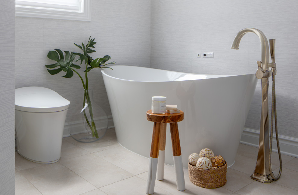 Design ideas for a medium sized contemporary ensuite bathroom in Newark with freestanding cabinets, beige cabinets, a freestanding bath, an alcove shower, a bidet, white walls, porcelain flooring, an integrated sink, engineered stone worktops, beige floors, a sliding door, white worktops, a shower bench, a single sink, a freestanding vanity unit and wallpapered walls.