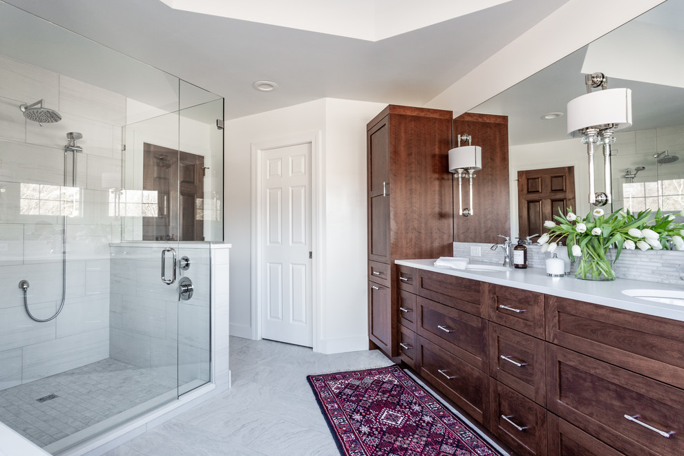 Inspiration for a large transitional master gray tile and mosaic tile porcelain tile and gray floor bathroom remodel in Indianapolis with shaker cabinets, brown cabinets, a two-piece toilet, white walls, an undermount sink, quartz countertops, a hinged shower door and white countertops