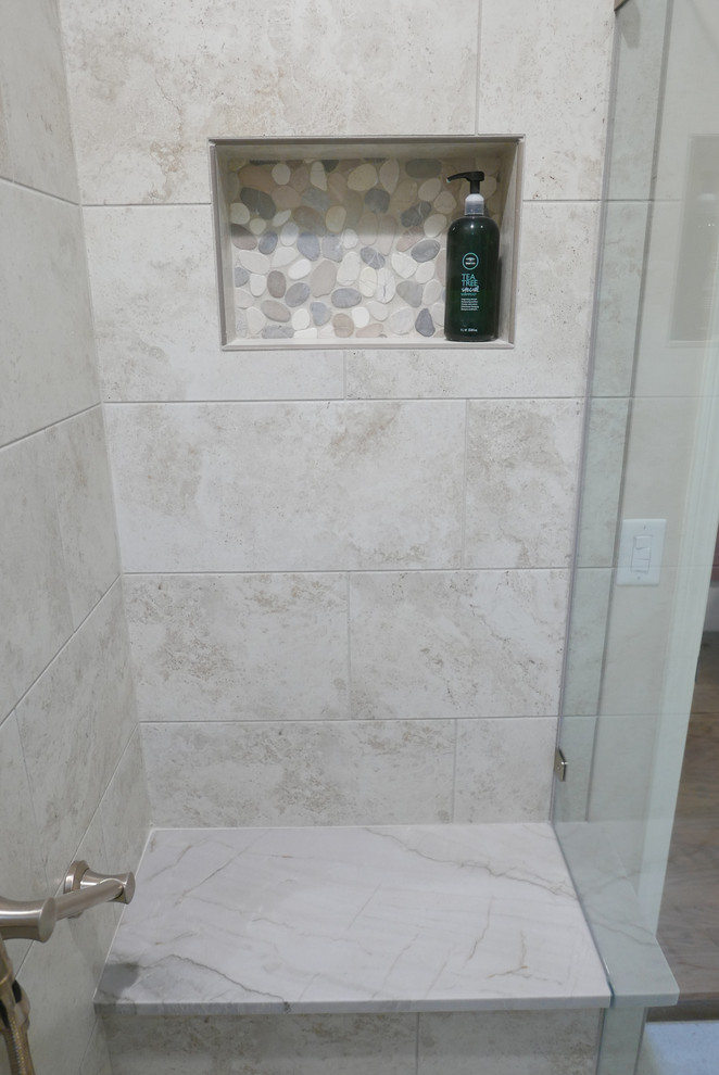 This is an example of a medium sized traditional ensuite bathroom in Other with shaker cabinets, beige cabinets, an alcove shower, a one-piece toilet, beige tiles, porcelain tiles, brown walls, porcelain flooring, a submerged sink, quartz worktops, beige floors, a hinged door and beige worktops.