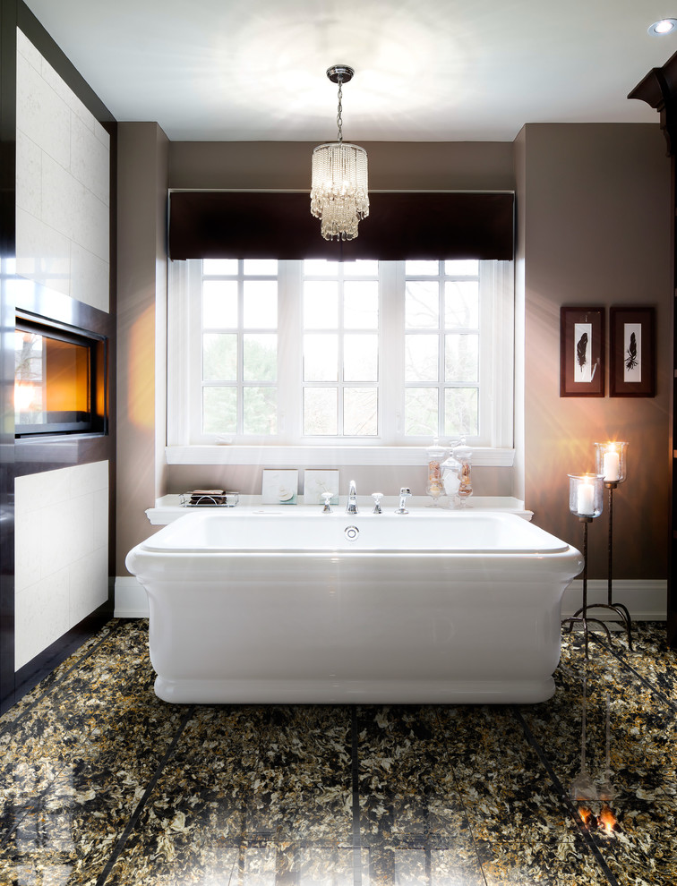 Design ideas for a classic bathroom in Toronto with a freestanding bath, multi-coloured tiles and beige walls.