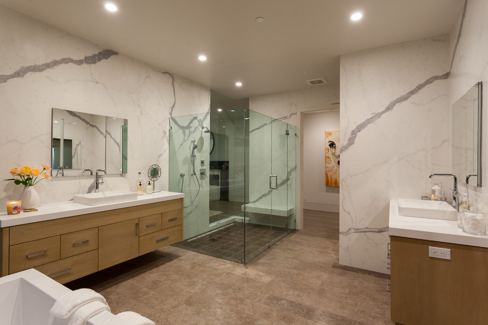 Inspiration for a contemporary ensuite bathroom in Orange County with flat-panel cabinets, medium wood cabinets, a corner shower, multi-coloured walls, a built-in sink and a hinged door.