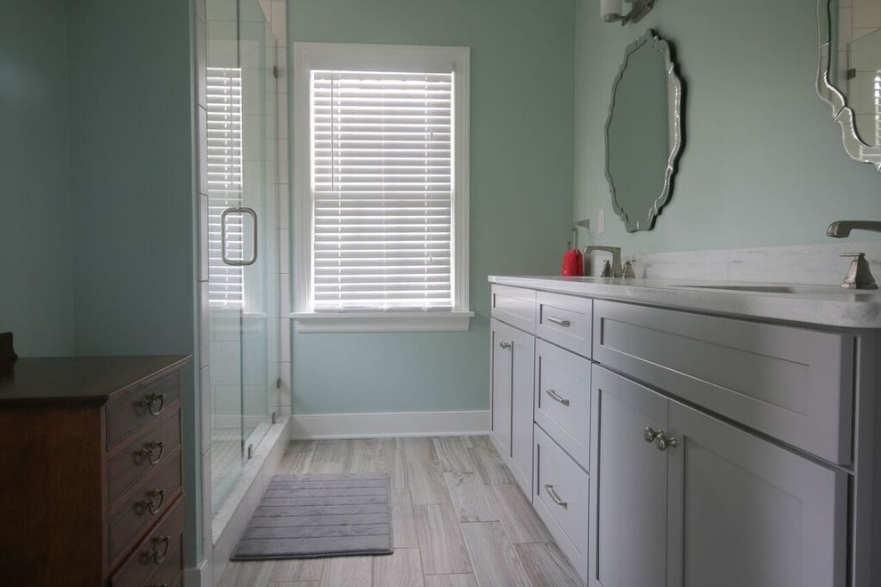 Example of a mid-sized transitional master vinyl floor alcove shower design in Richmond with shaker cabinets, gray cabinets, blue walls, an undermount sink and quartzite countertops