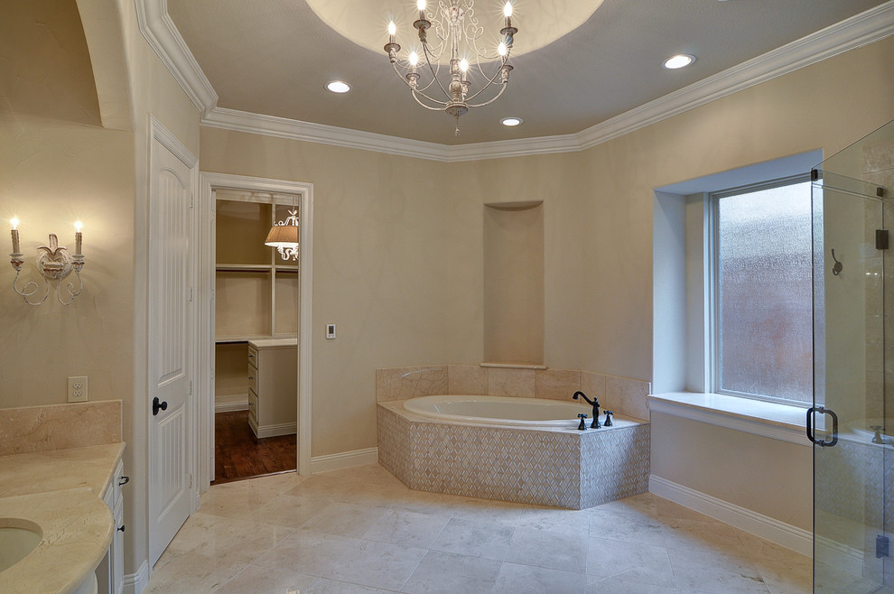 Large elegant beige tile and stone tile marble floor bathroom photo in Dallas with an undermount sink, raised-panel cabinets, marble countertops, a one-piece toilet and beige walls