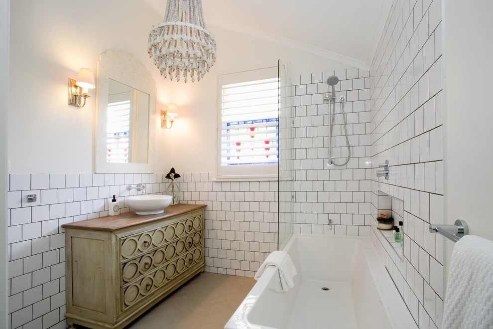 Inspiration for a coastal shower room bathroom in Brisbane with an alcove bath, a shower/bath combination, white tiles, white walls, a vessel sink, an open shower and recessed-panel cabinets.