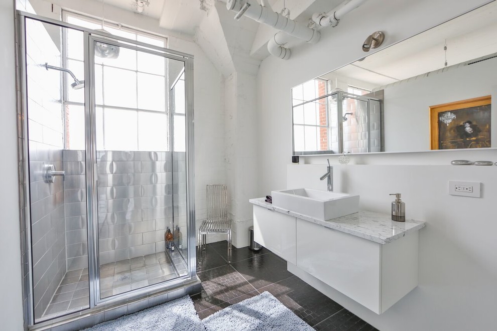 Inspiration for a medium sized industrial shower room bathroom in Austin with flat-panel cabinets, white cabinets, a corner shower, metal tiles, white walls, a vessel sink, a hinged door and brown floors.