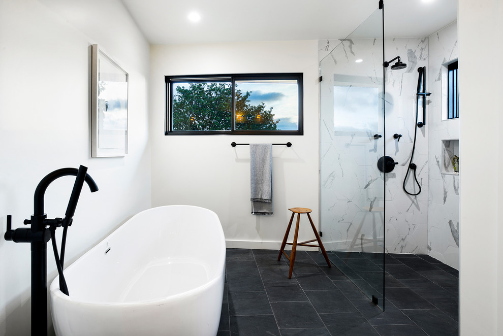 Bohemian ensuite bathroom in Los Angeles with flat-panel cabinets, white cabinets, a walk-in shower, white tiles, metro tiles, white walls, porcelain flooring, a submerged sink, quartz worktops, blue floors, a hinged door and white worktops.