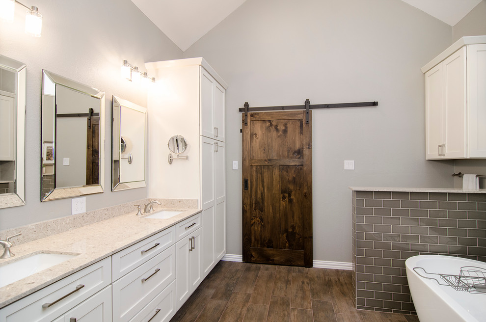 Bathroom - mid-sized traditional master brown tile and ceramic tile ceramic tile bathroom idea in Dallas with an undermount sink, shaker cabinets, white cabinets, solid surface countertops, a one-piece toilet and beige walls